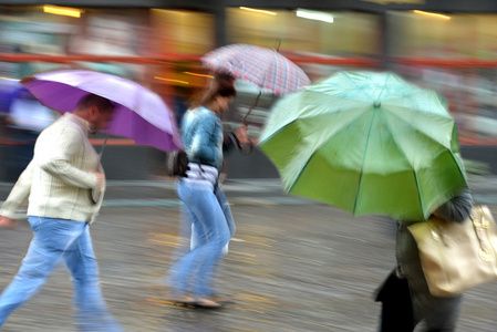 人走在街上，在一个下雨天