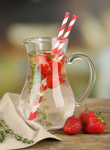 美味清凉饮料的草莓和百里香，在明亮的背景上