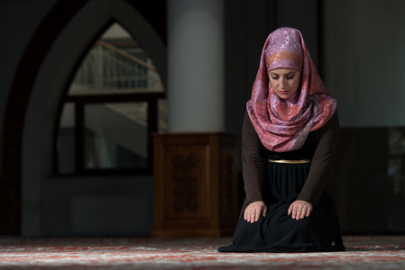 在清真寺做礼拜的穆斯林女人照片