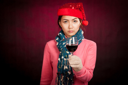杯酒红色的圣诞帽的亚洲女孩
