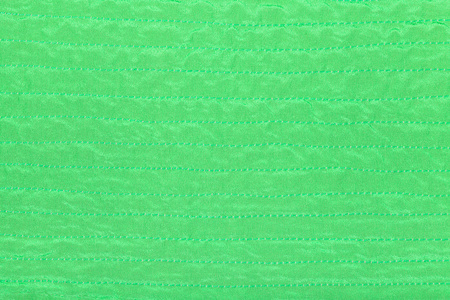 绿色的颜色纺织纹理的缝合丝绸