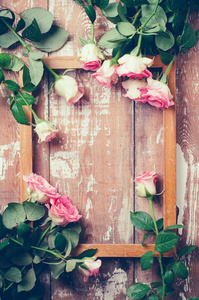 粉红色的玫瑰和一个木制的框架