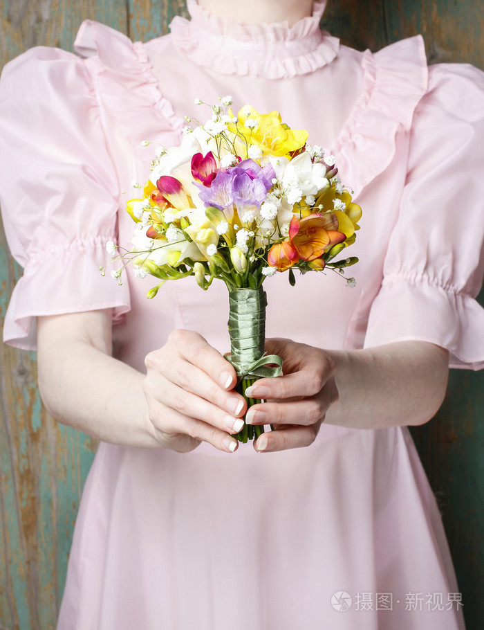 穿着复古的服装抱着花束的年轻女子
