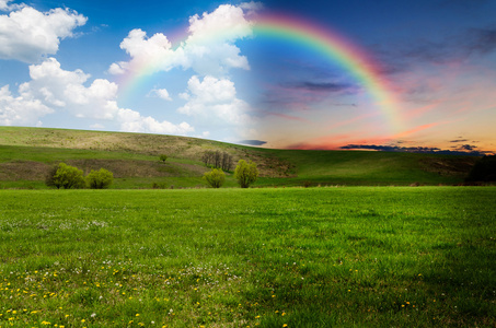 田野彩虹绿色的田野 彩虹,白天和黑夜的概念照片