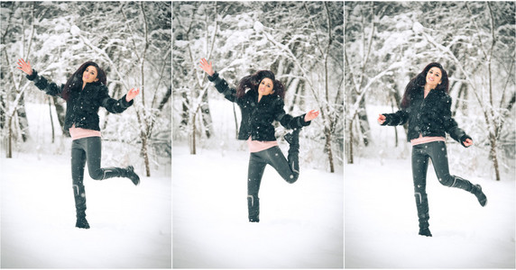 快乐的黑发女孩玩雪冬季景观中的视图。美丽的年轻女性在冬天背景。年轻漂亮的女人，在室外的一个冬日温暖柔软的衣服