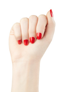 在女性手上有白色红色指甲油修指甲