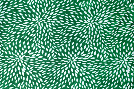 在绿色织物上的抽象花卉图案