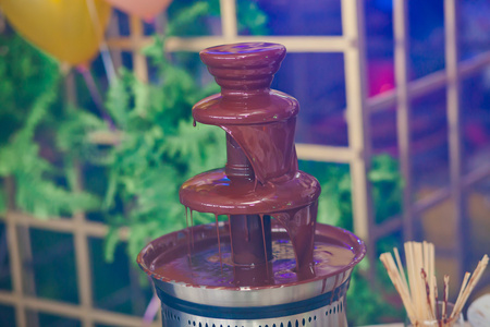 巧克力喷泉喷泉上孩子的充满活力的图片与孩子们玩耍的孩子生日聚会和