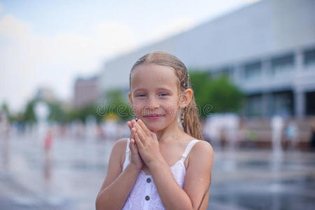 小女孩在露天喷泉玩得很开心