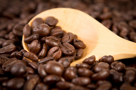 复古色调的木勺咖啡豆放咖啡豆作为背景，选择性焦点