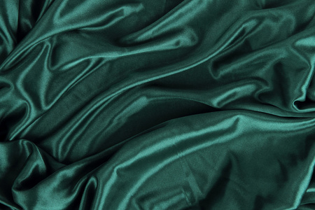 暗绿色缎丝绒布织物背景照片