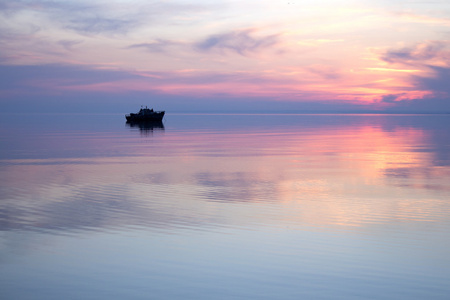 一艘小船在日落时的剪影
