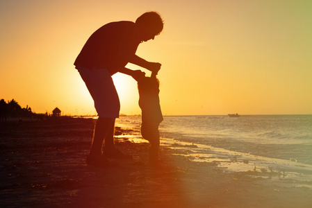 父亲和小女儿在夕阳的剪影