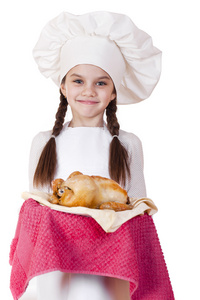 烹饪和人们的观念微笑在厨师的帽子的小女孩