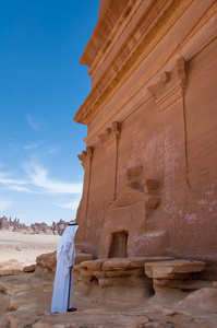 Saudian outside a Nabatean tomb in Madan Saleh archeological s