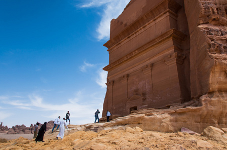 People entering a Nabatean tomb in Madan Saleh archeological s