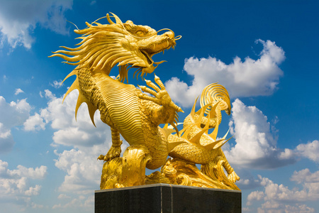 蓝蓝的天空背景上的金色中国龙照片