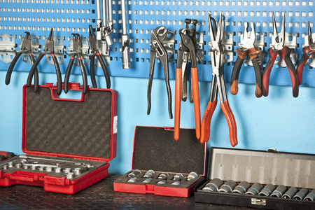 不同的汽车修理工具设置在墙上照片
