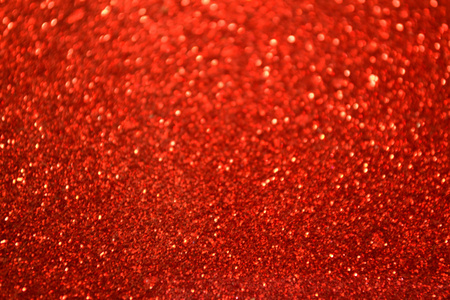 明亮的和抽象的模糊红色背景与波光粼粼闪光照片