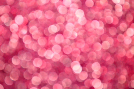 光明和抽象模糊粉红色背景与波光粼粼闪光