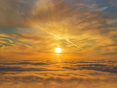金色的夕阳的天空云层之上照片