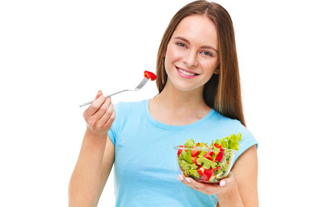 吃新鲜的沙拉上孤立合适的健康女人的画像