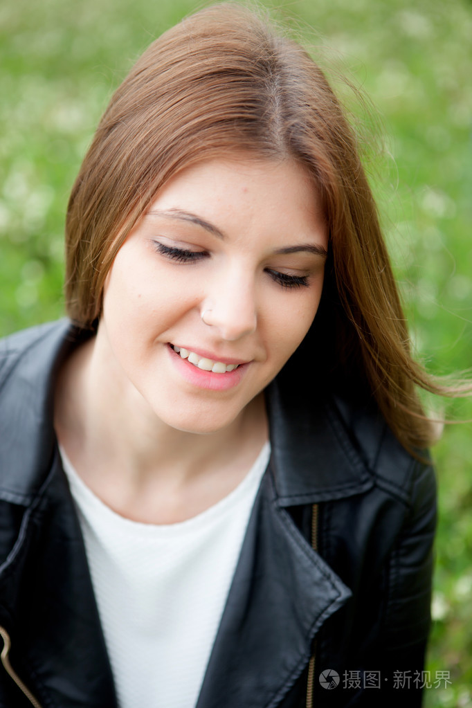 沉思的漂亮女人在公园放松