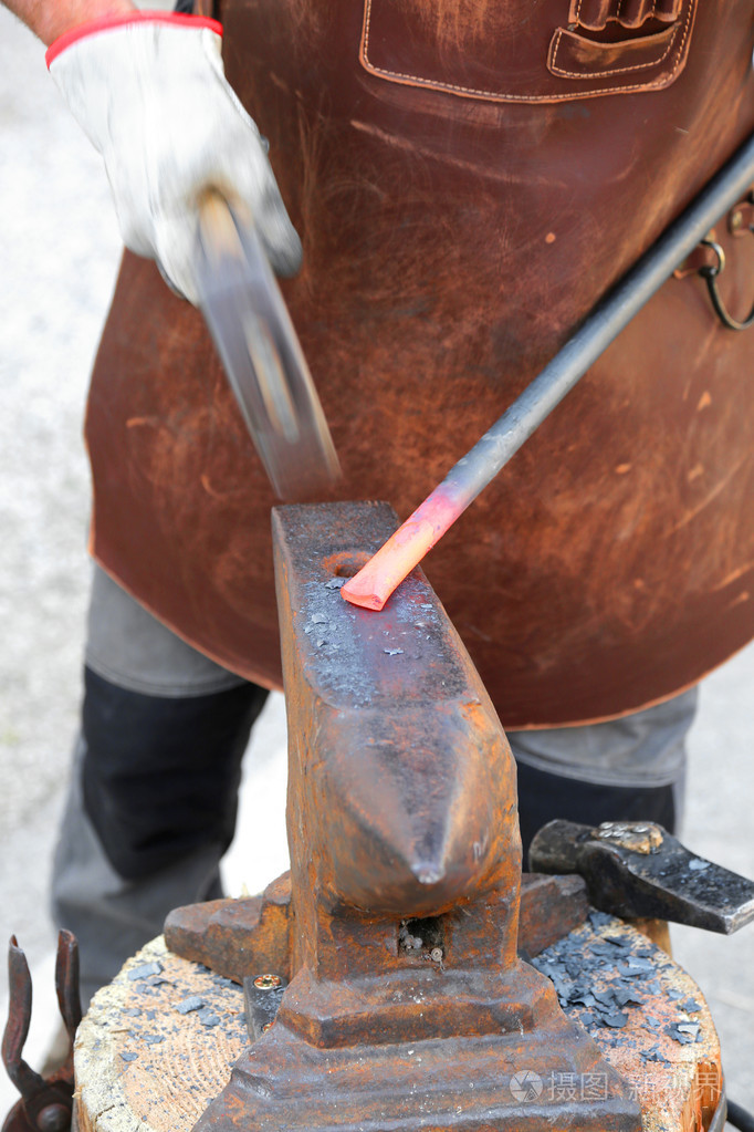 铁匠在铁砧上锤以热铁