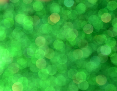 光明和抽象模糊绿色背景与波光粼粼闪光