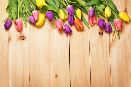 春天的花束在木地板纹理上。 美丽的郁金香