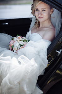 漂亮的新娘，在一辆车的画像。一个非常害羞的新娘，在车窗外的特写肖像
