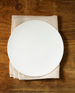 空盘子餐具和餐巾放在木制的背景