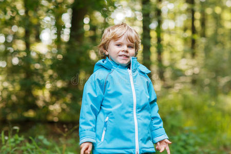 穿着蓝色防水雨衣的金发小男孩肖像