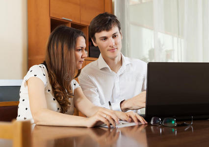 年轻夫妇在笔记本电脑里看财务文件