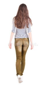 穿着牛仔裤行走的女人的后视图。
