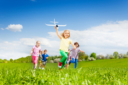 带着飞机玩具跑的女孩和孩子