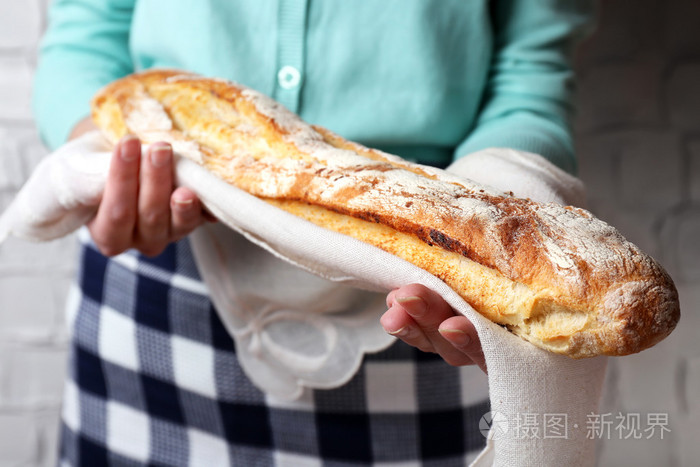 女人抱着可口的新鲜面包关闭