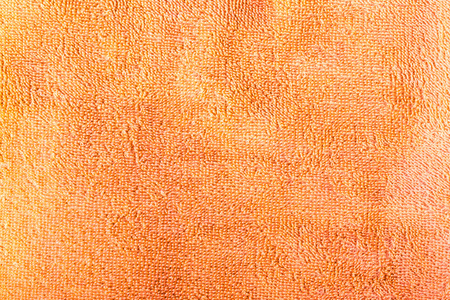 为背景的橙色毛巾的结构
