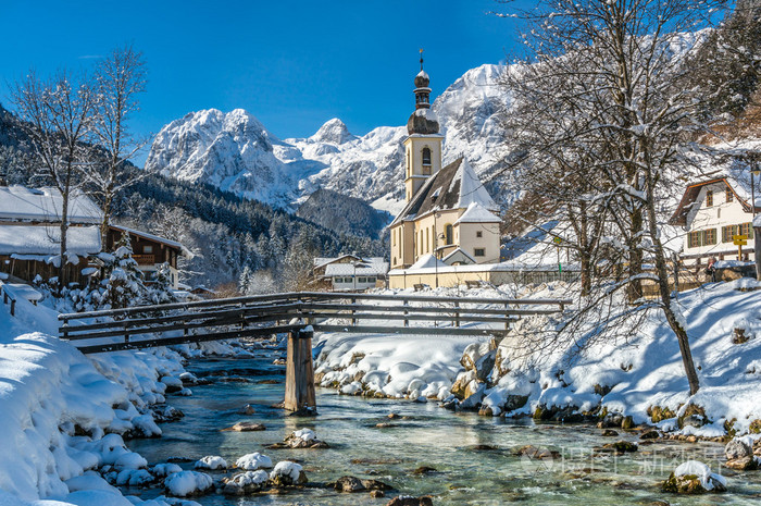 scenic winter landscape in the bavarian alps with parish church