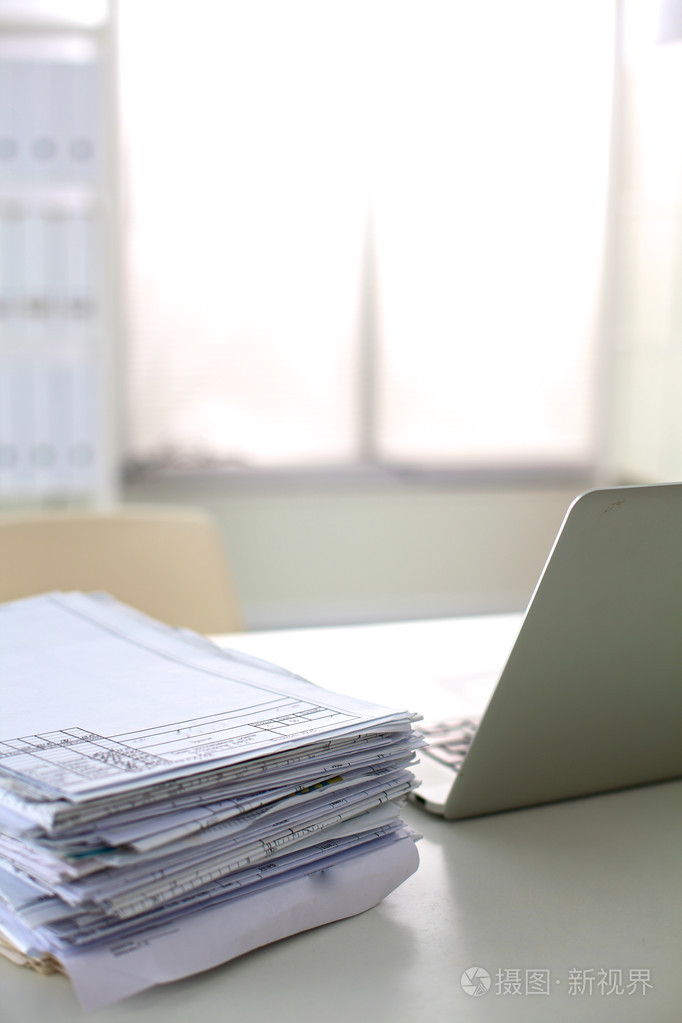 一叠文件在计算机桌上