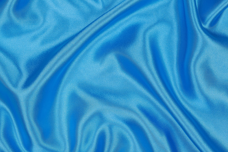 蓝色的丝绸布的波浪抽象背景