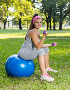 健身健康微笑年轻女子练习普拉提球