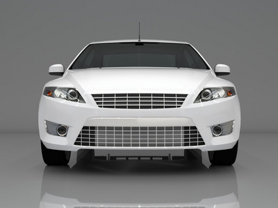 汽车前视图.一辆灰色的背景上的白色轿车的形象照片