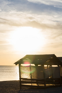 躲避在日落时太阳的海滩小屋