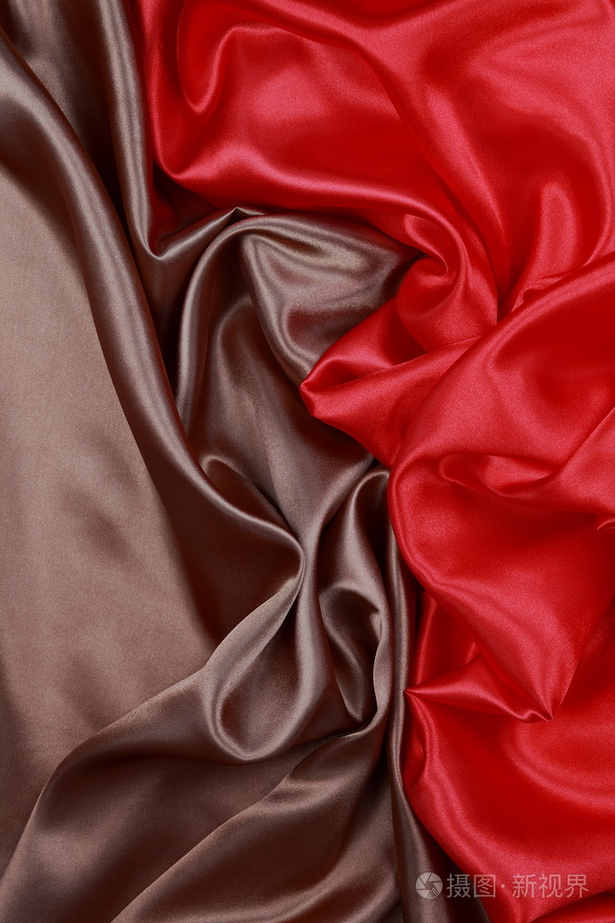 棕色和红色丝缎布的波浪褶皱纹理背景