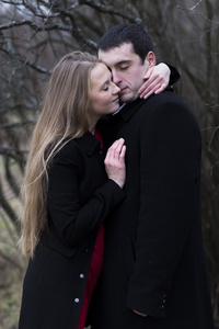 年轻的夫妇在闭着眼睛公园接吻