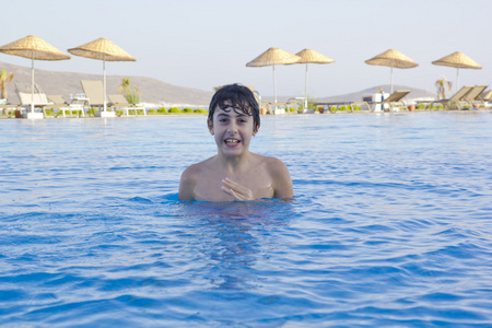在游泳池里的快乐少年