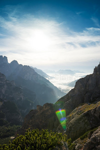 意大利风景，白云石岩石后面的日出，太阳耀斑