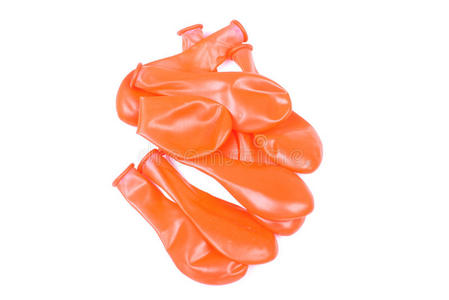 放气的气球孤立背景上橙色的放气气球照片