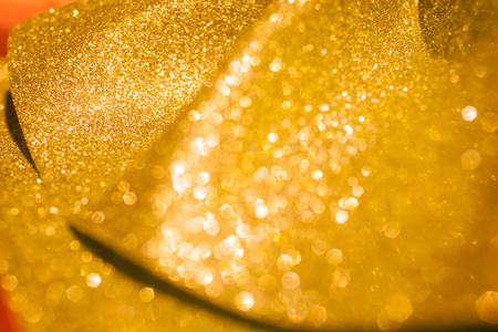 金色闪光圣诞抽象背景。闪亮的金色光芒